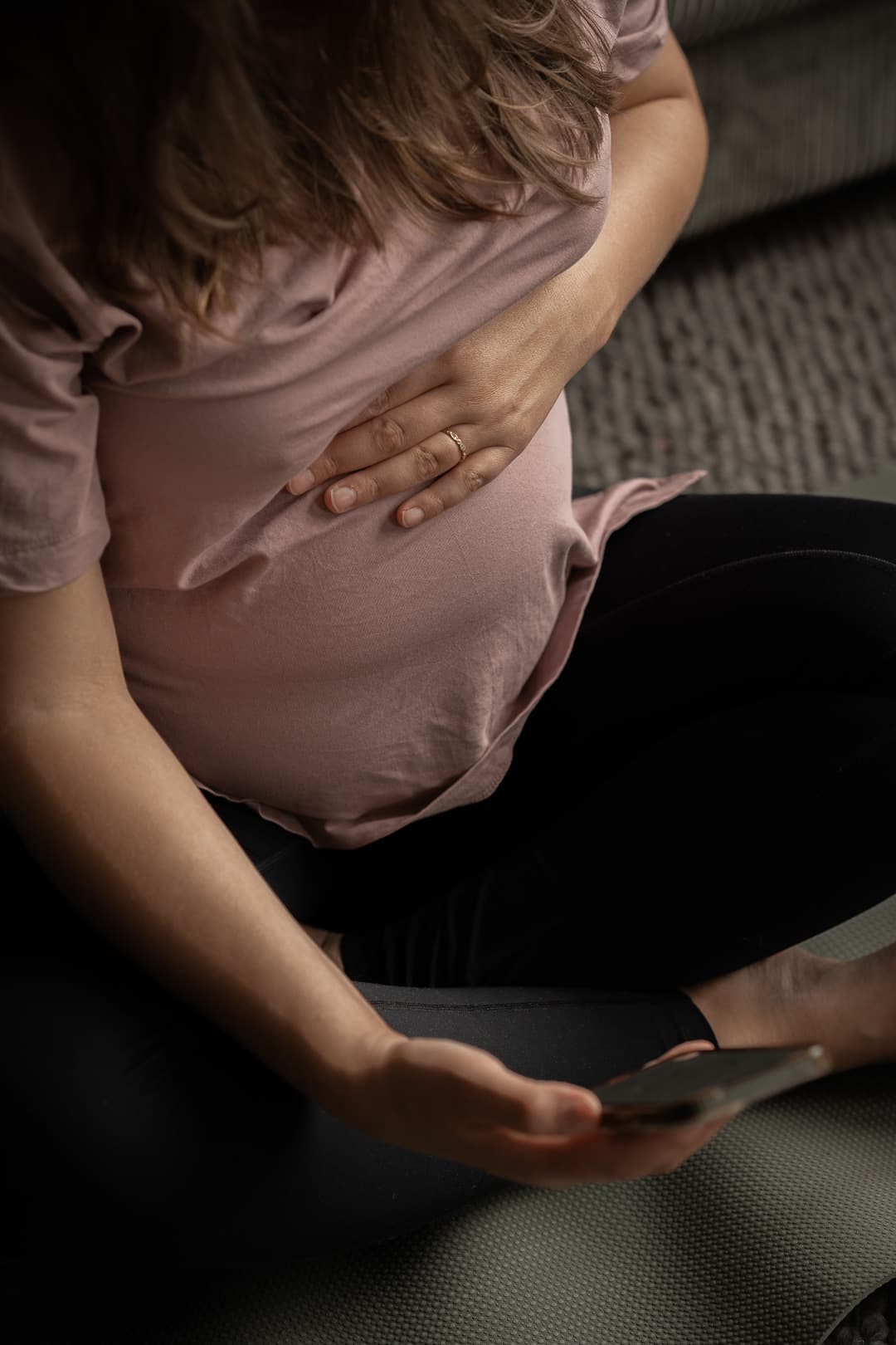 A pregnant woman with her hand on her belly